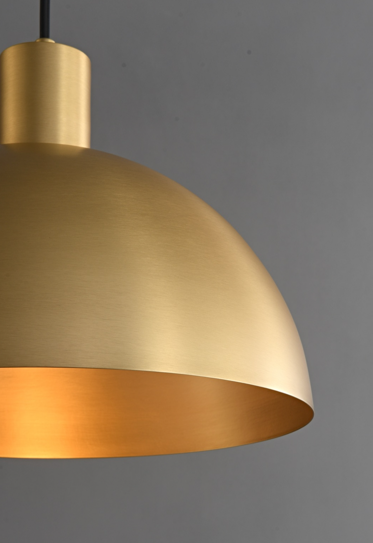 Brushed brass light fitting in a dark interior